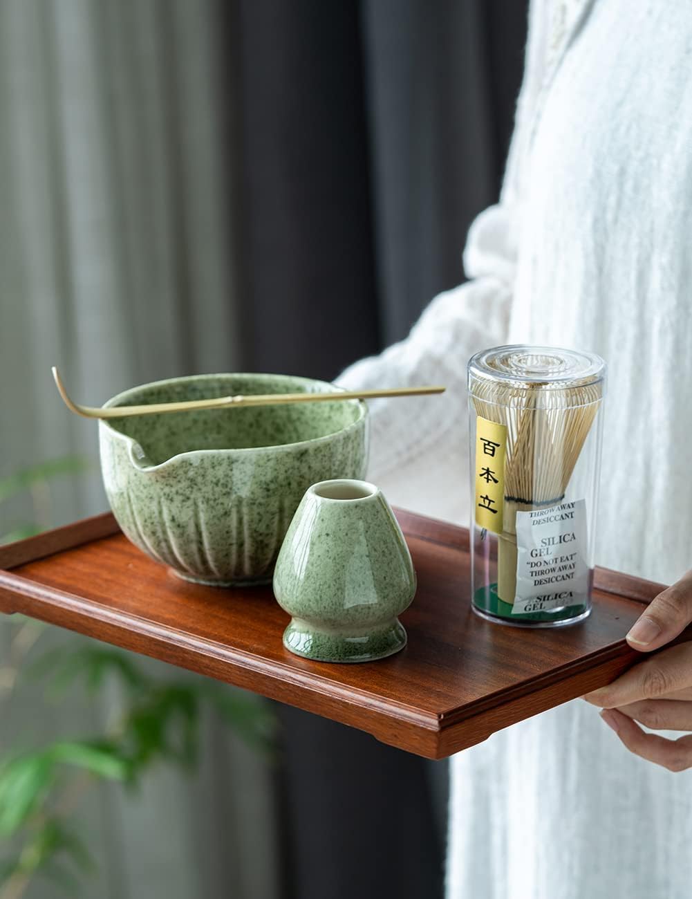 Mottled green matcha bowl set arranged with whisk holder, scoop, and sifter
