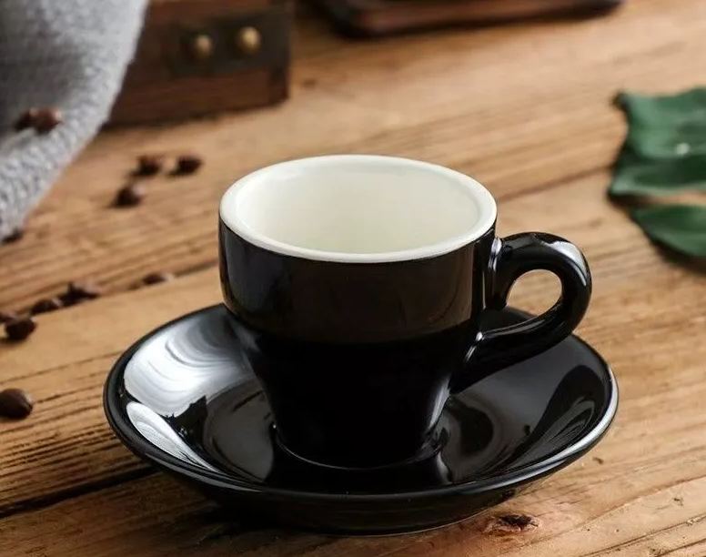 Front view of the black ceramic 2.5 oz espresso cup and saucer