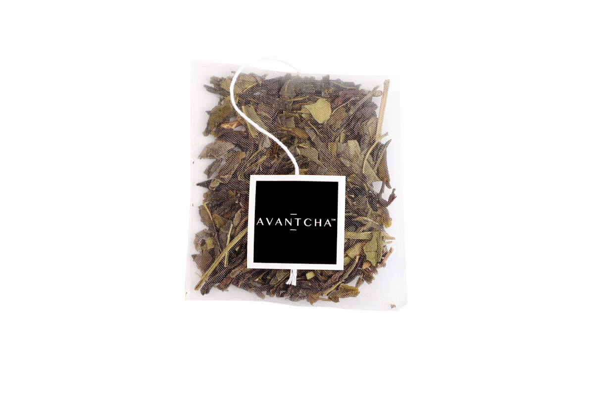 Tropical Green teabag with pineapple pieces, strawberry slices, and peach 