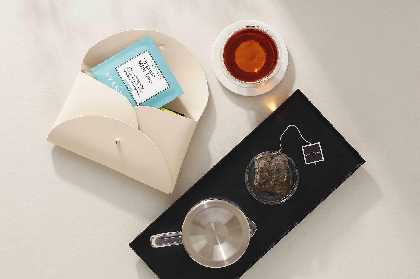 Brewed silk teabag, with Travel Tea Pouch, highlighting portable tea enjoyment anywhere