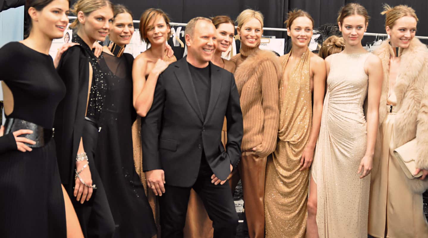 michael kors posing for a photo