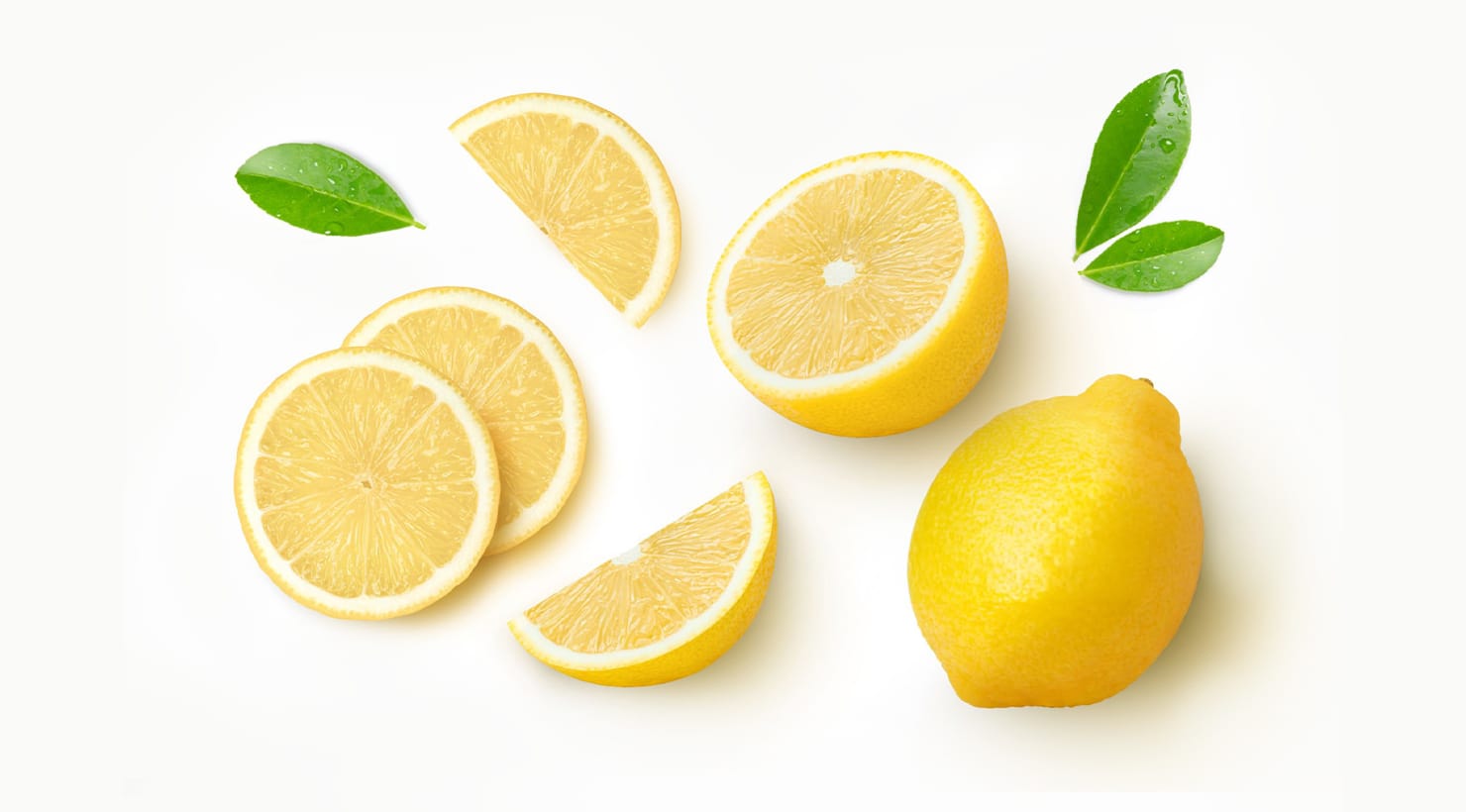 A whole lemon, a juicy cut lemon half, and a yellow silicone food keeper on a marble countertop — editorial food photography for lemon storage guide
