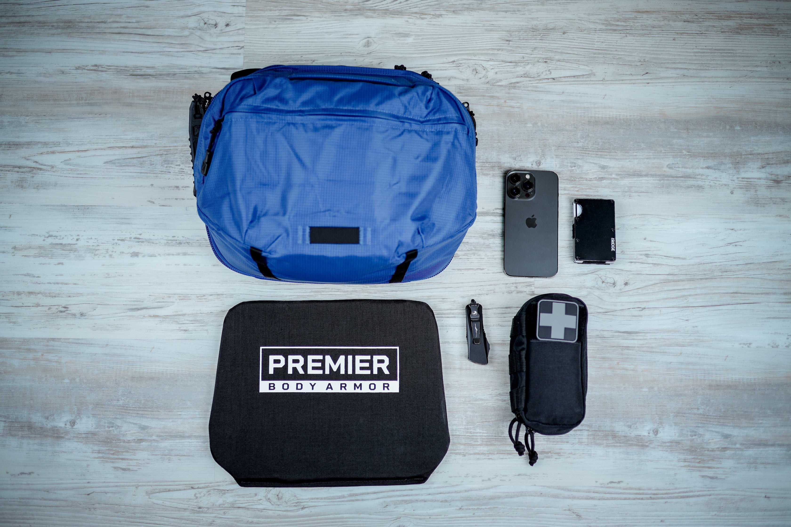 Image of Vertx Navigator with EDC travel gear and a ballistic panel.