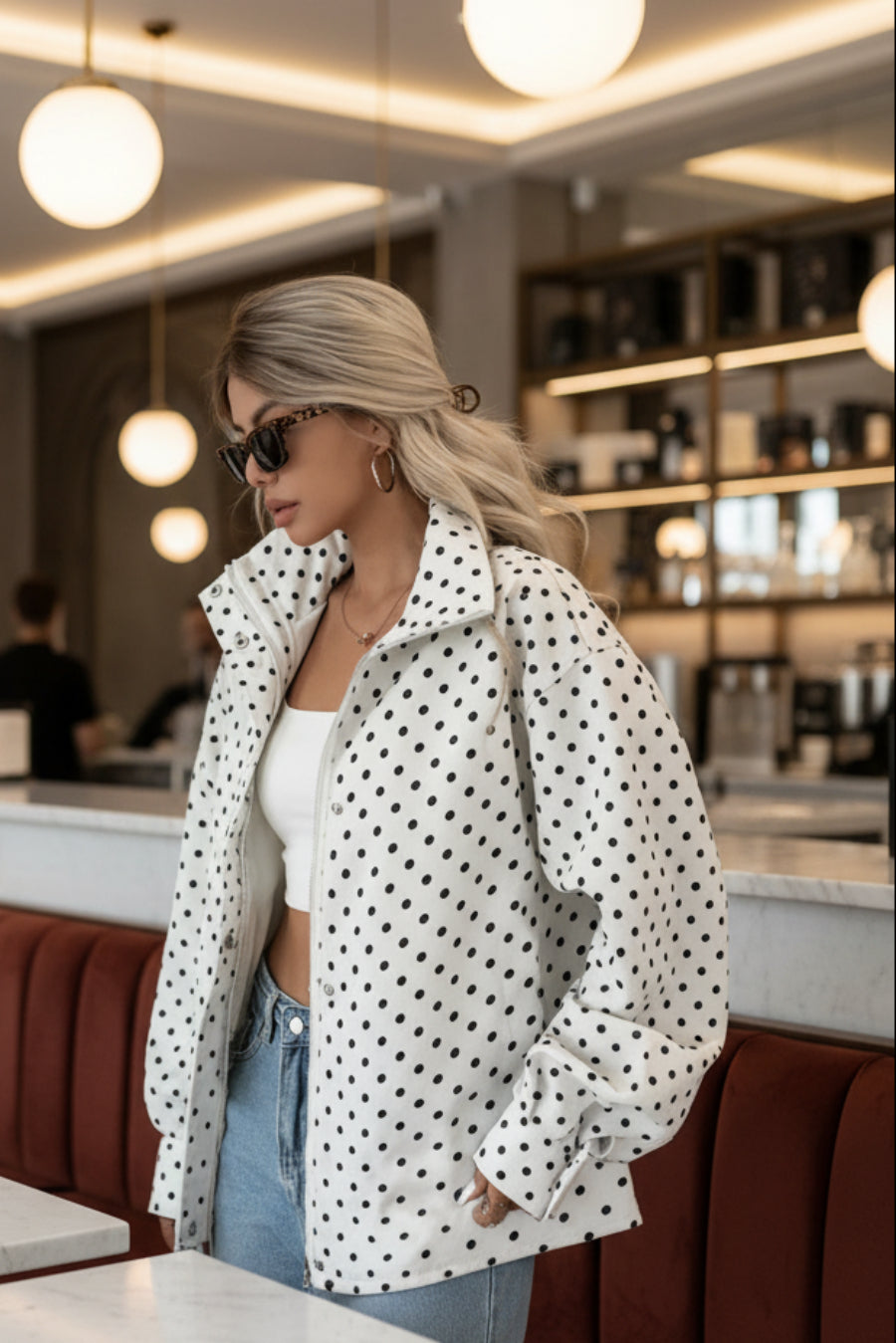 White polka dot zip-up jacket with black dots, relaxed fit, worn open over a white crop top
