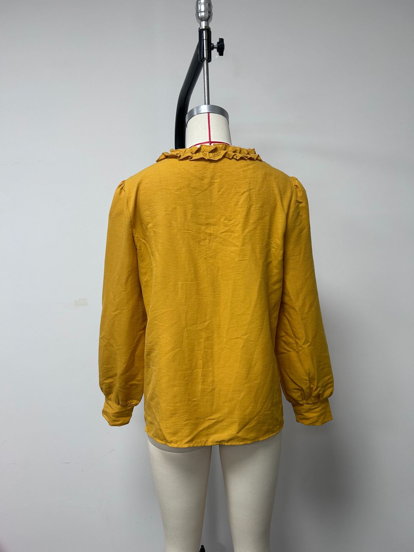 Women's loose linen blouse — ruffle neckline detail close-up