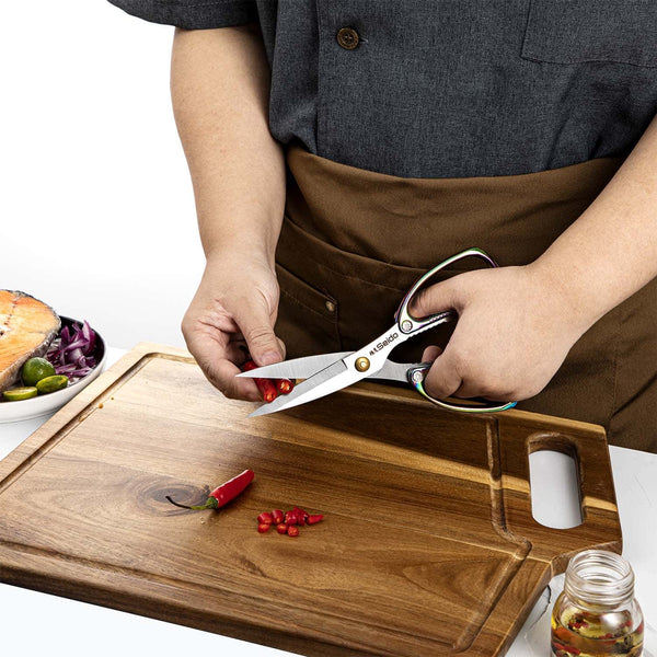 A chef using the Awabi shears to cut hot red peppers