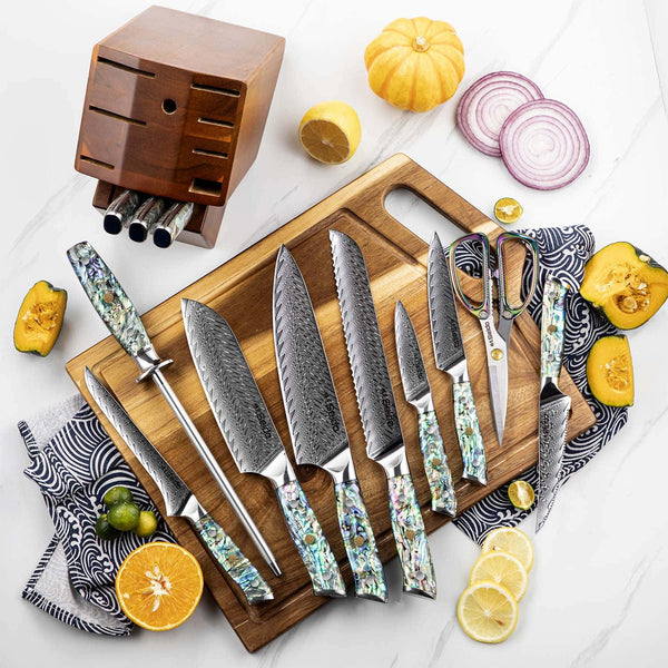The 13 piece Awabi knife block set displayed on a cuttng board with ingredients