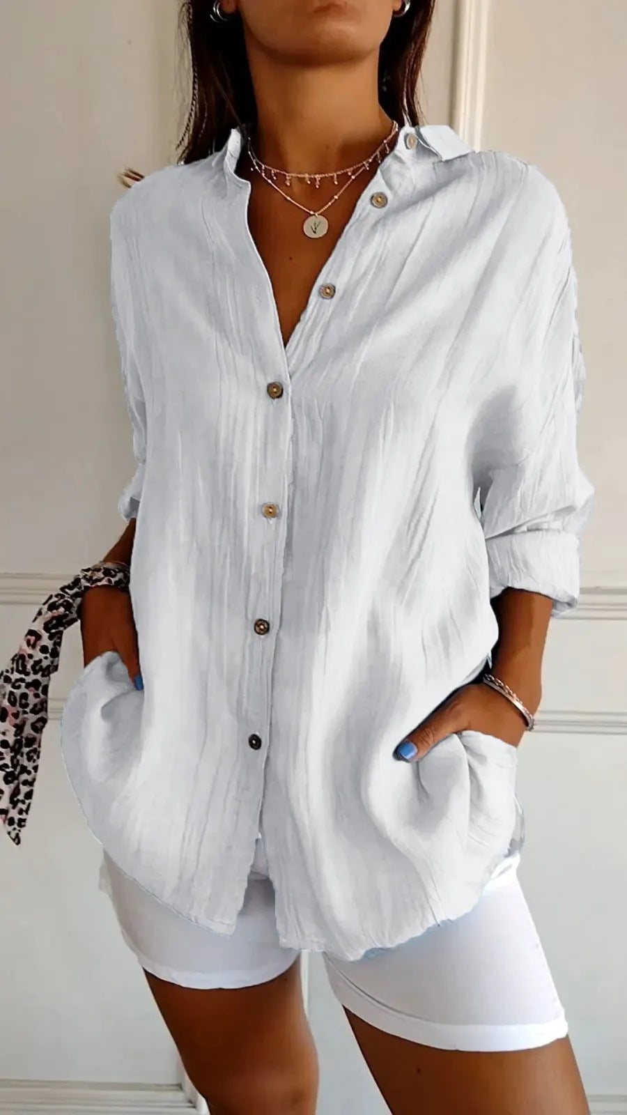 Women's oversized lapel button-down shirt in white – front view showing lapel collar, button closure, and relaxed fit