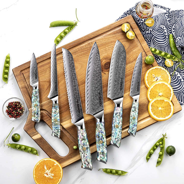 Awabi knife set on a cutting board with fruit and ingredients