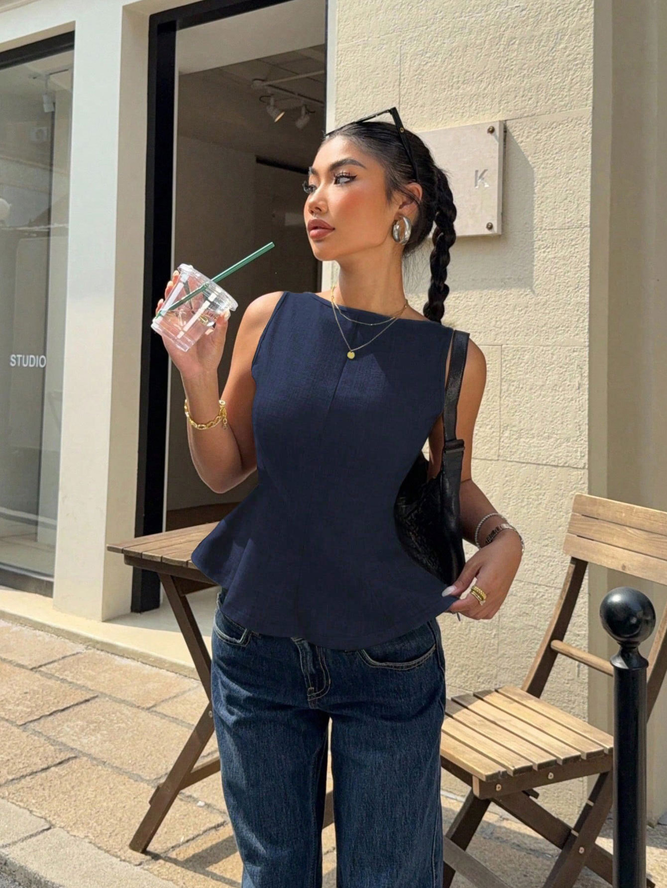 Women's sleeveless peplum top — side profile view