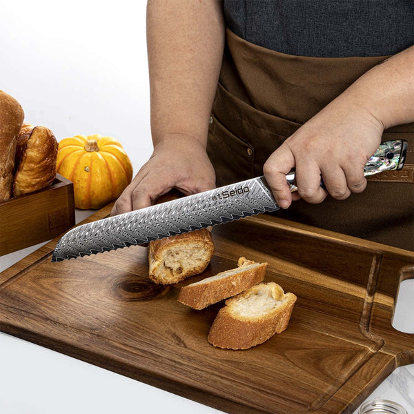 A chef using the Awabi Serrated knife to slice bread against a cutting board