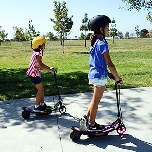 razor; electric scooters; girls riding on pathway