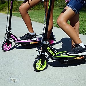 razor;  electric scooter; girls standing on pathway
