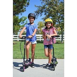 razor; electric scooter; girls standing on scooters on pathway