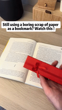 Decorative metal bookmark ruler in use