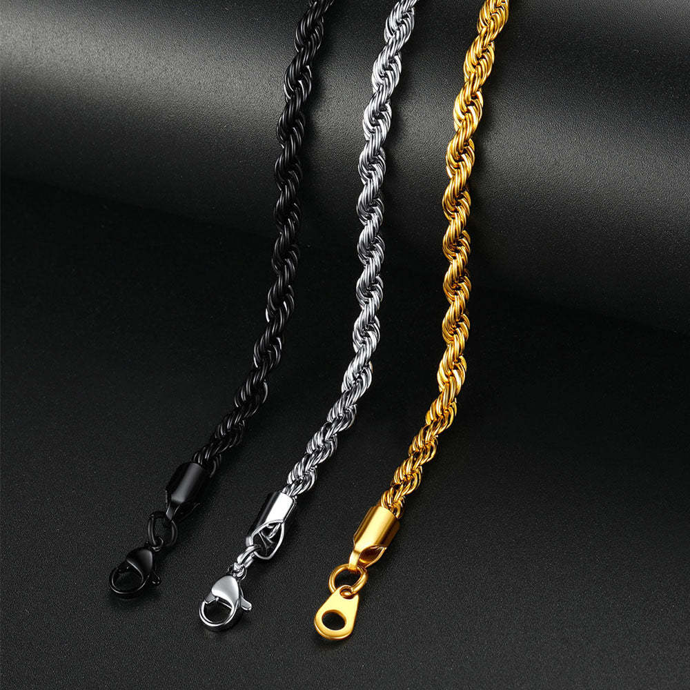 Three chain necklaces in black, silver, and gold on a dark background
