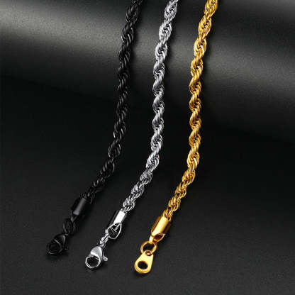 Three chain necklaces in black, silver, and gold on a dark background
