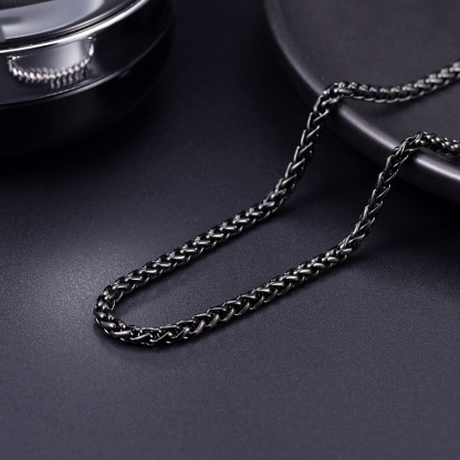Black stainless steel wheat chain on dark background