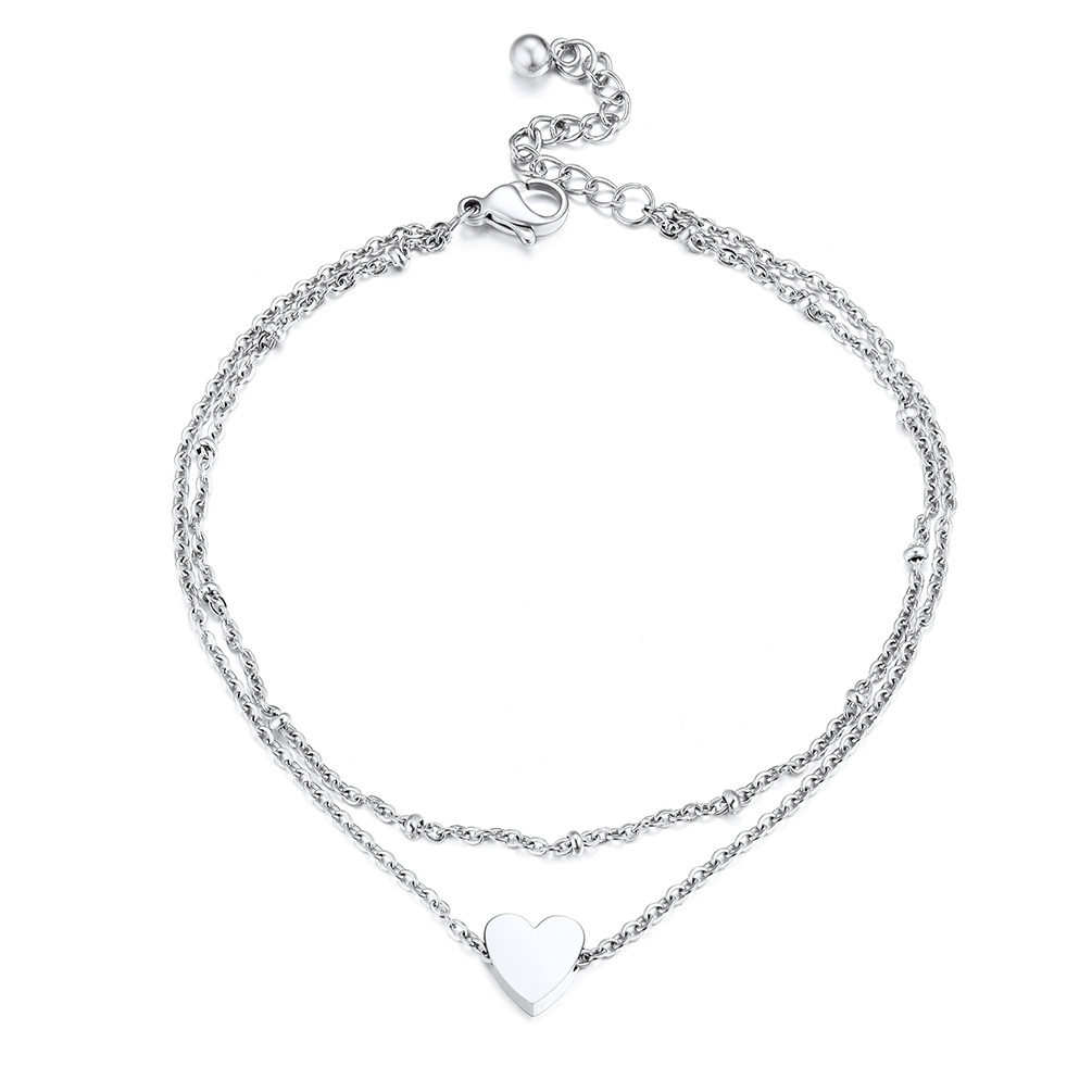 double chain anklet with beaded design and heart charm on white background