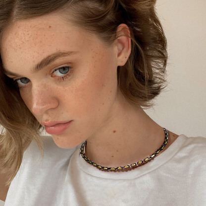 Female model wearing square Byzantine chain necklace in a short choker-style length