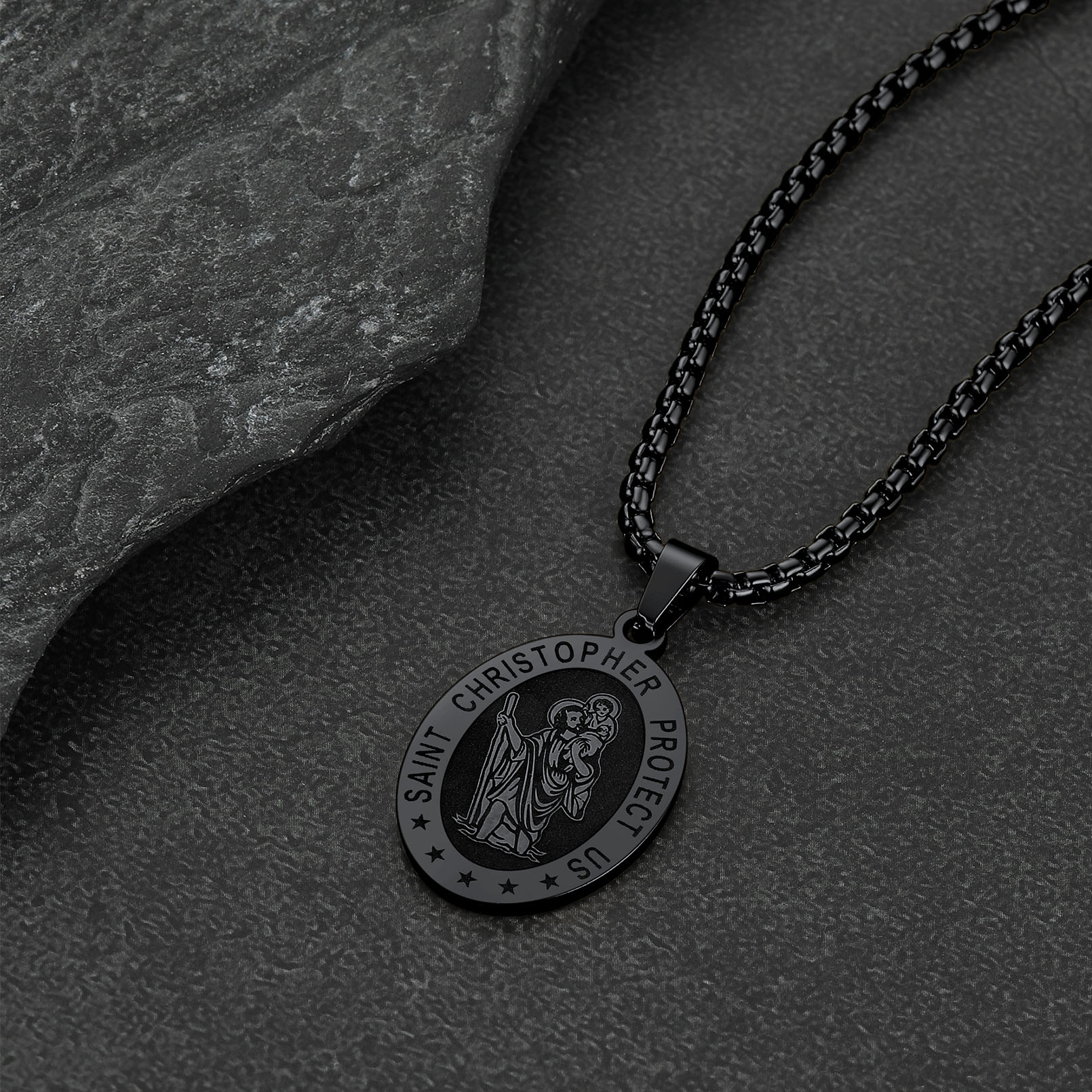Black Saint Christopher necklace on black stone background