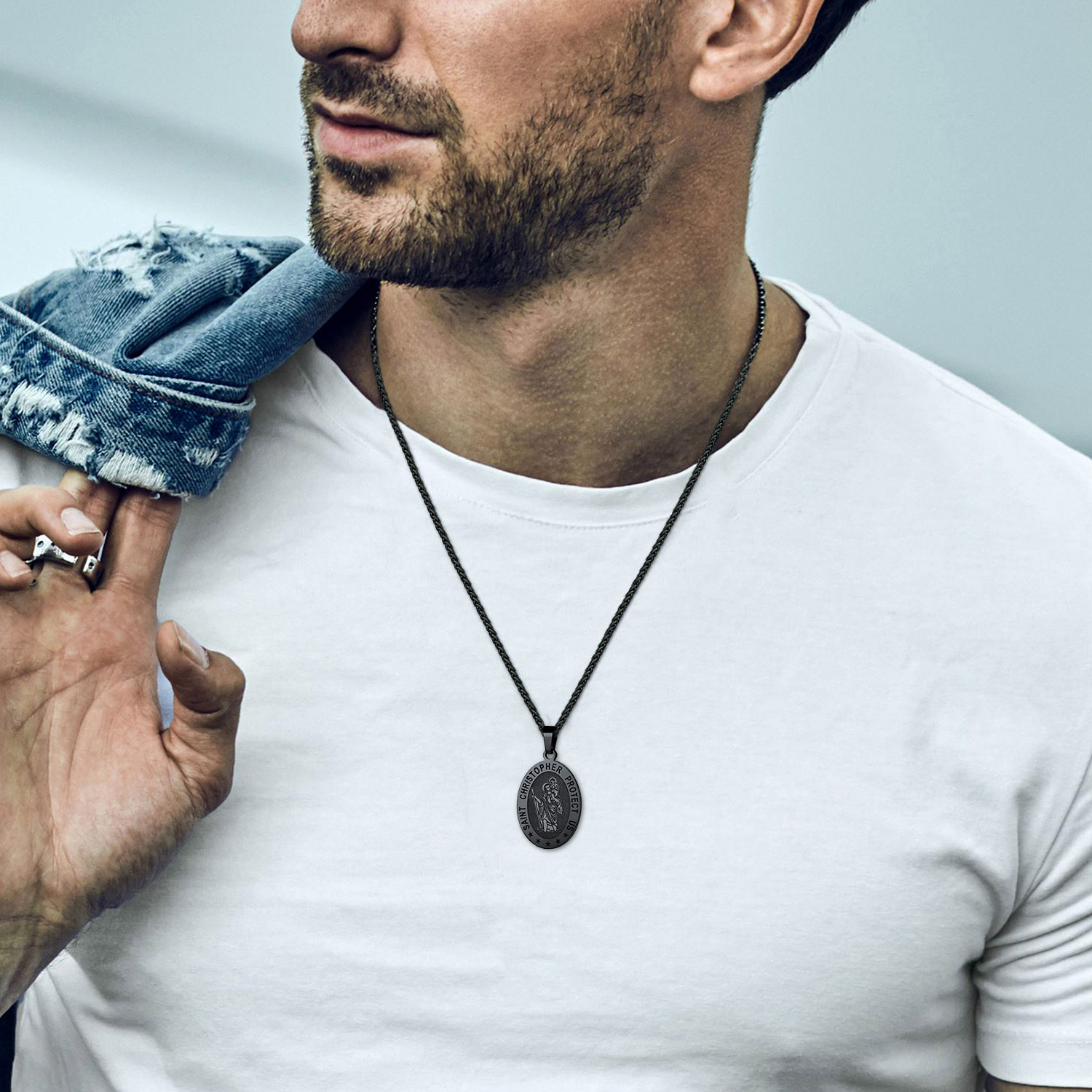 Black Saint Christopher necklace worn with casual outfit