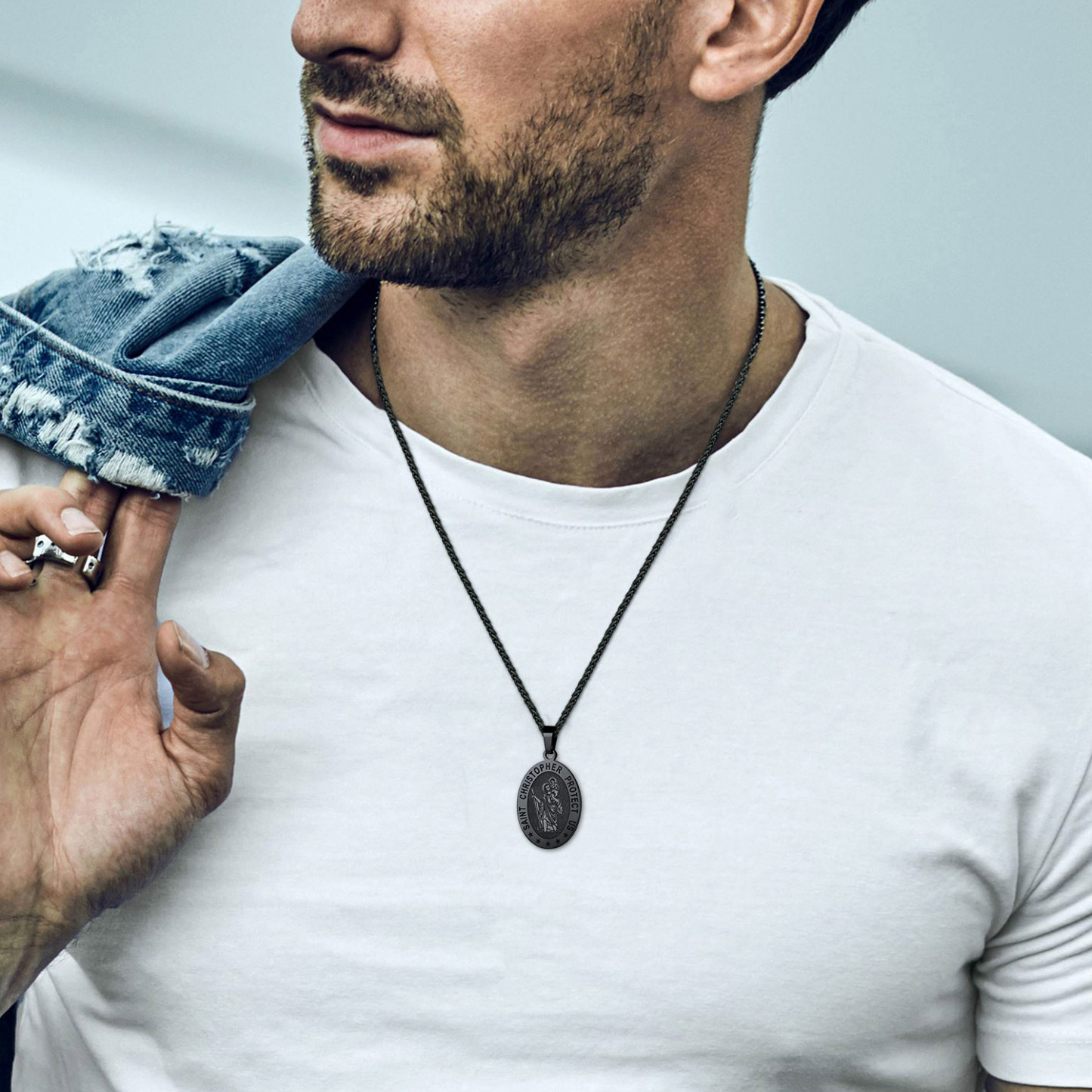 Black Saint Christopher necklace worn with casual outfit