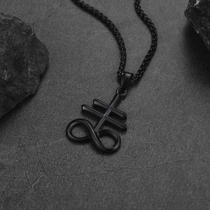 Black Leviathan Cross necklace on dark stone background
