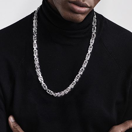 Male model wearing a silver square Byzantine chain necklace with casual black outfit