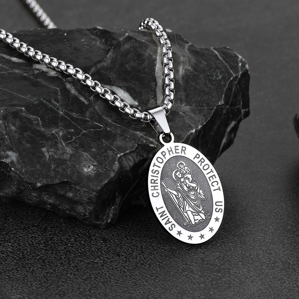 Saint Christopher necklace on black stone background