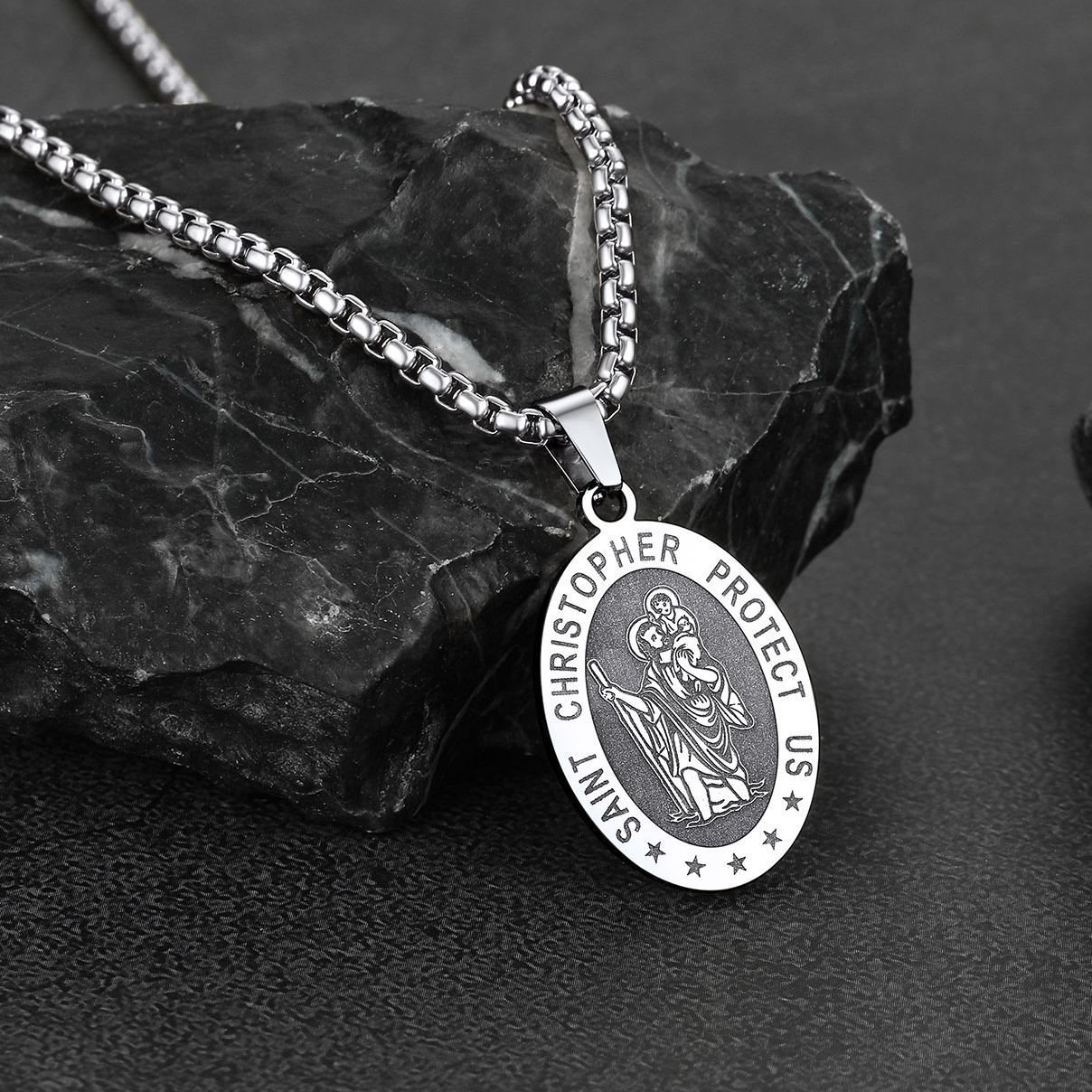 Saint Christopher necklace on black stone background