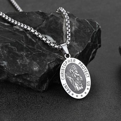 Saint Christopher necklace on black stone background