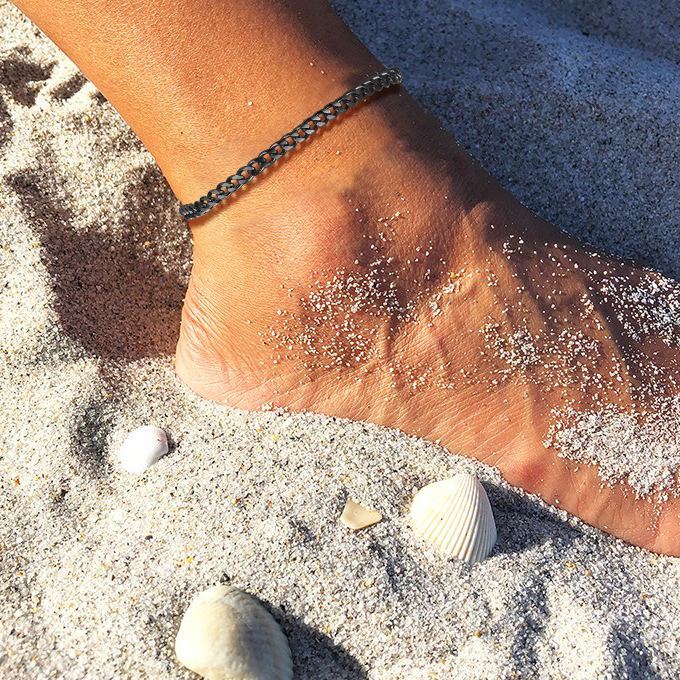 Dark ankle with silver-black chain anklet