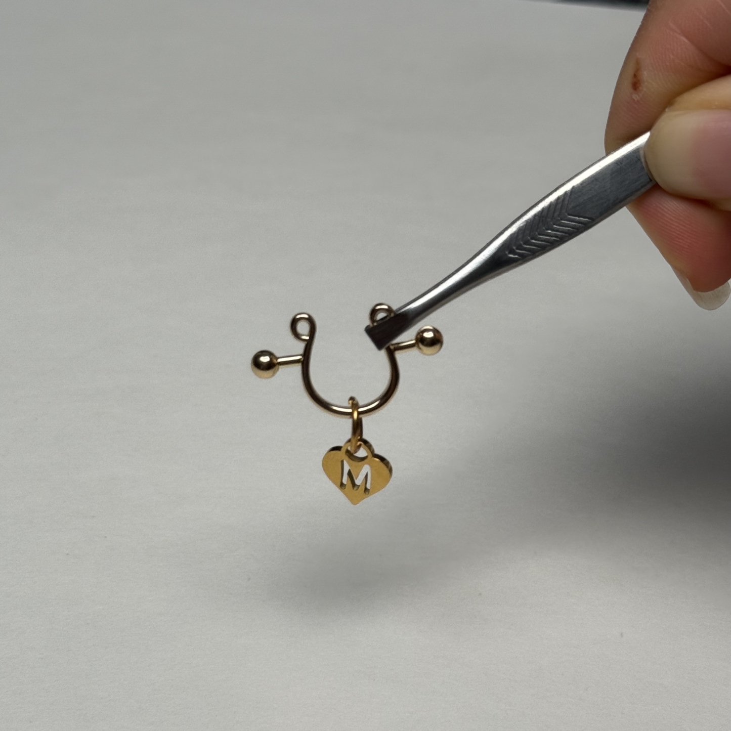 Custom letter nipple clamps