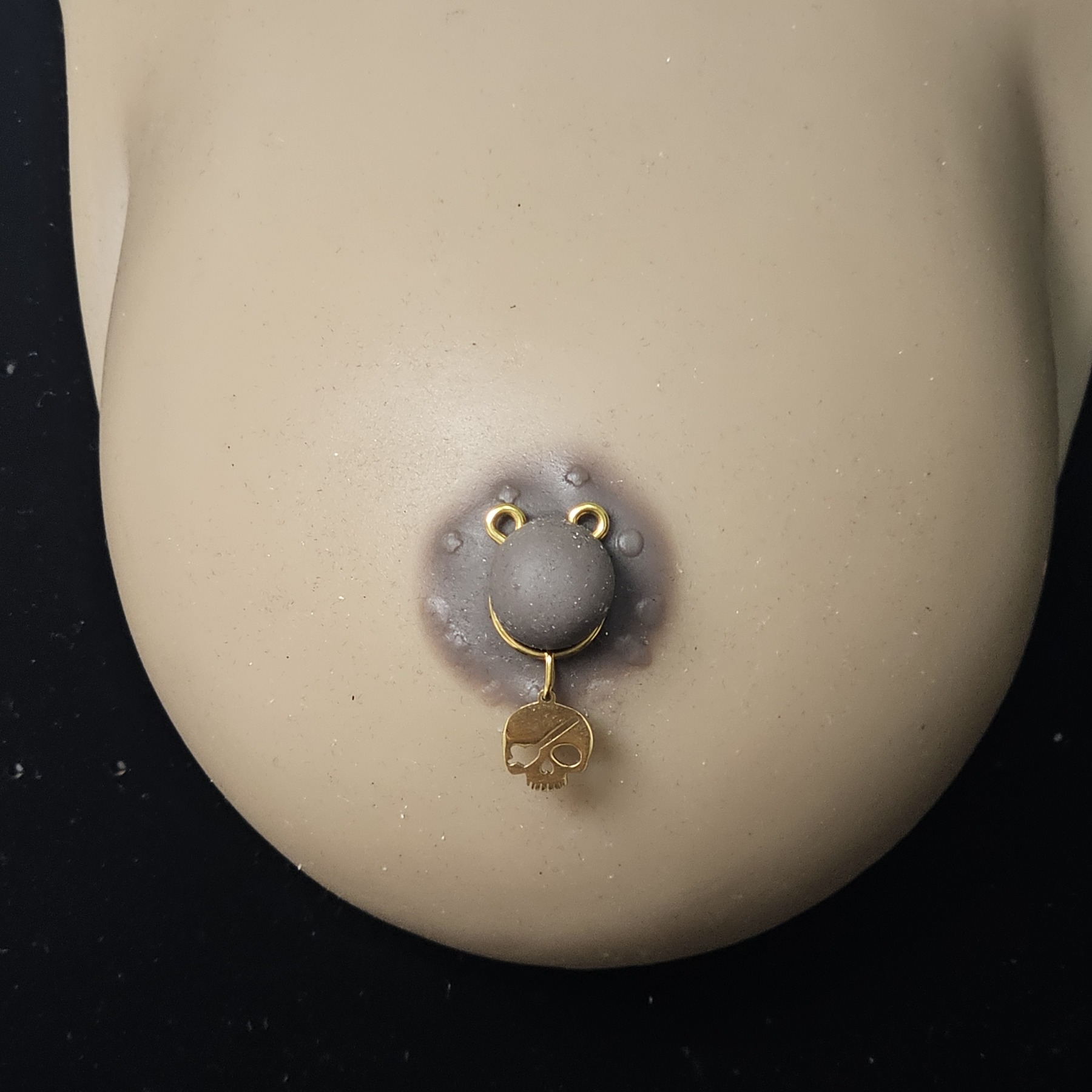 Gilded skull pendant
