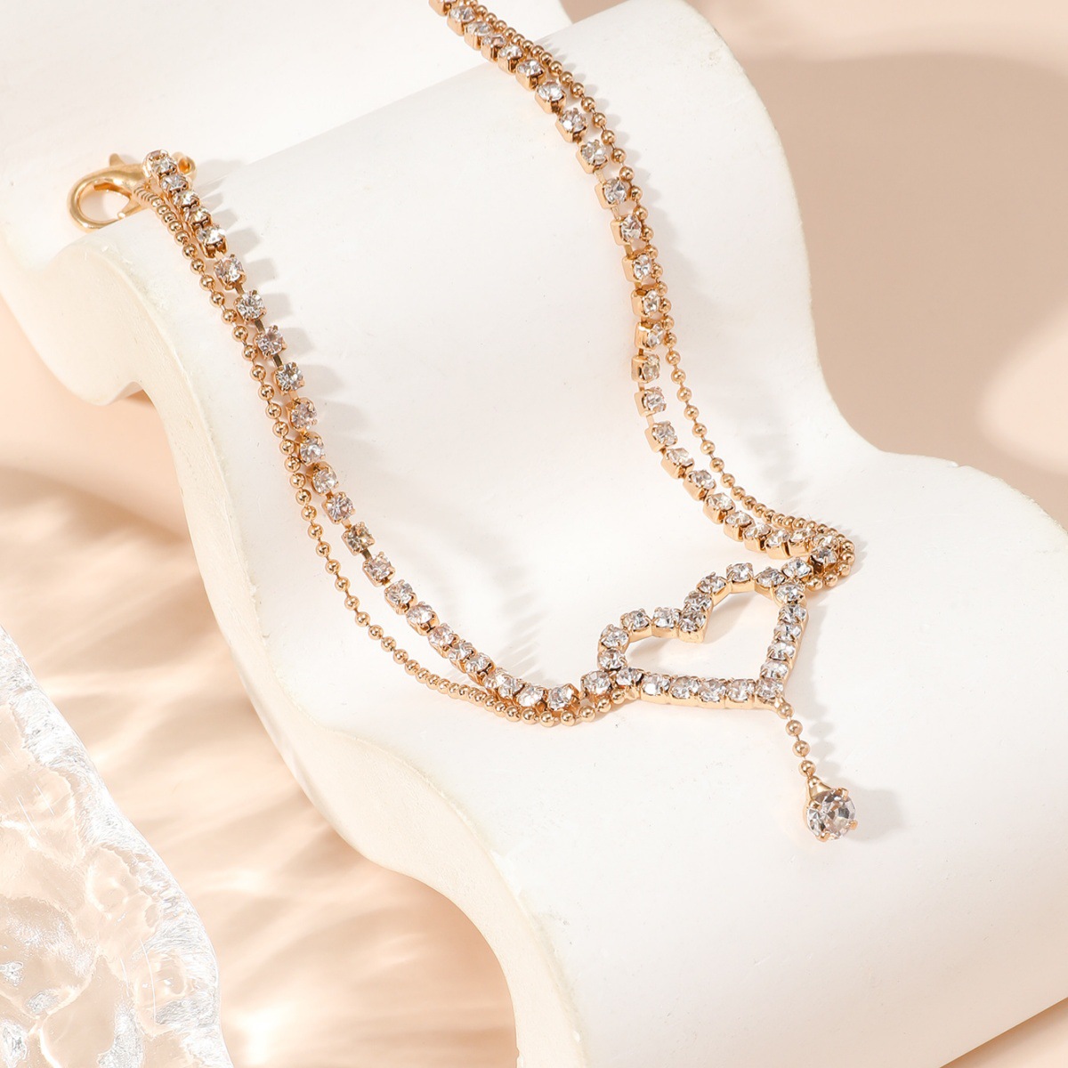 Diamond-encrusted heart-shaped anklet