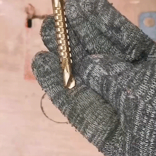 Titanium-coated serrated drill bit working on material