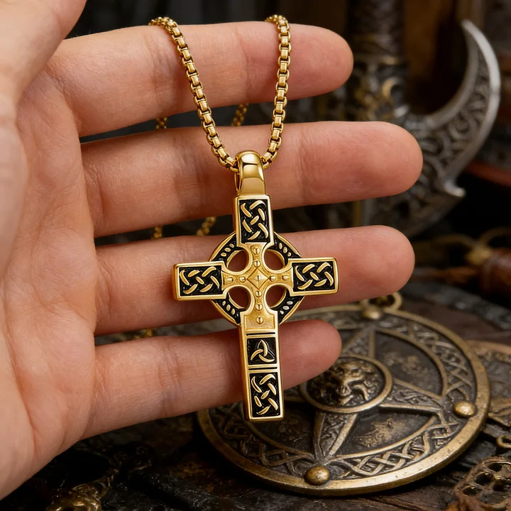 Hand wearing Celtic cross showing intricate details