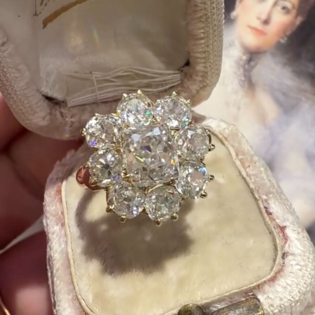 Floral-patterned round-cut white sapphire engagement ring