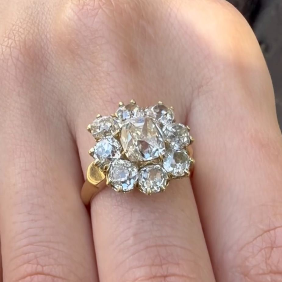 Floral-patterned round-cut white sapphire engagement ring