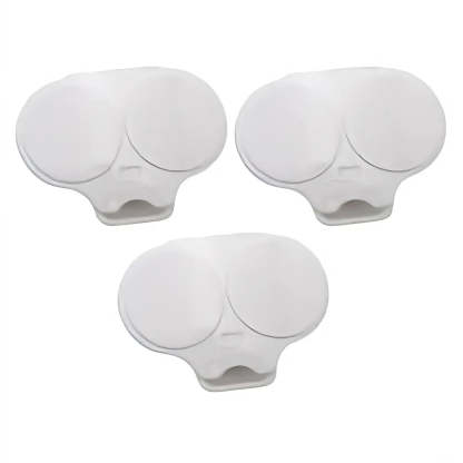Three white plastic replacement parts with oval circular tops and a small slot cutout at the base, arranged on a plain white background.