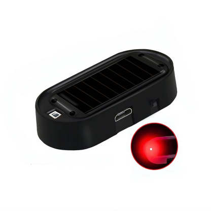 A black oval electronic device with a ribbed top surface, shown on a white background with a circular inset demonstrating a red light beam.