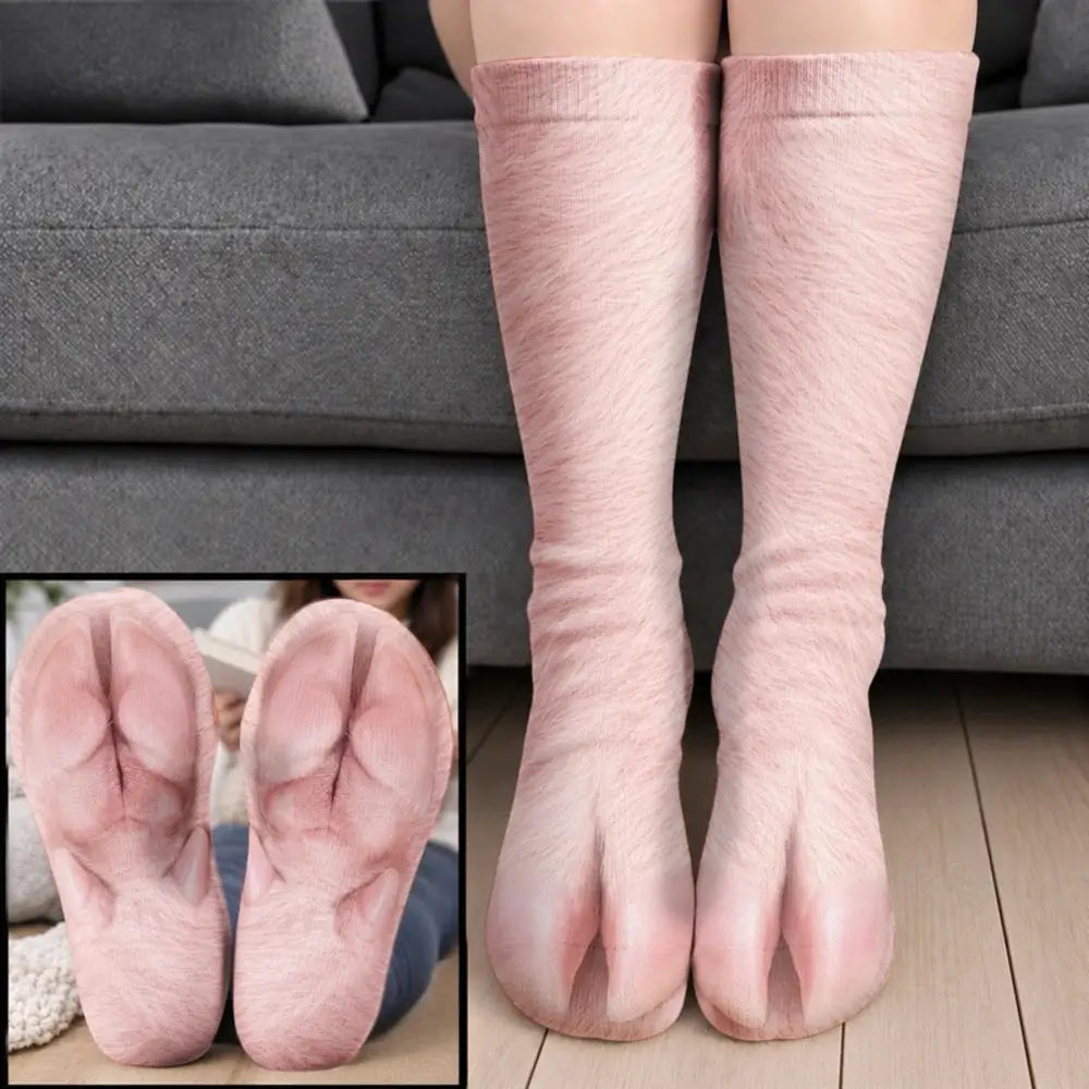 Soft pink pig foot socks with split toes worn on legs before a gray sofa