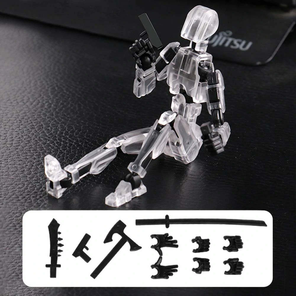 A transparent acrylic action figure of a kneeling robot or mecha on a black textured surface, with interchangeable black weapon and limb accessories shown in a white box at the bottom.
