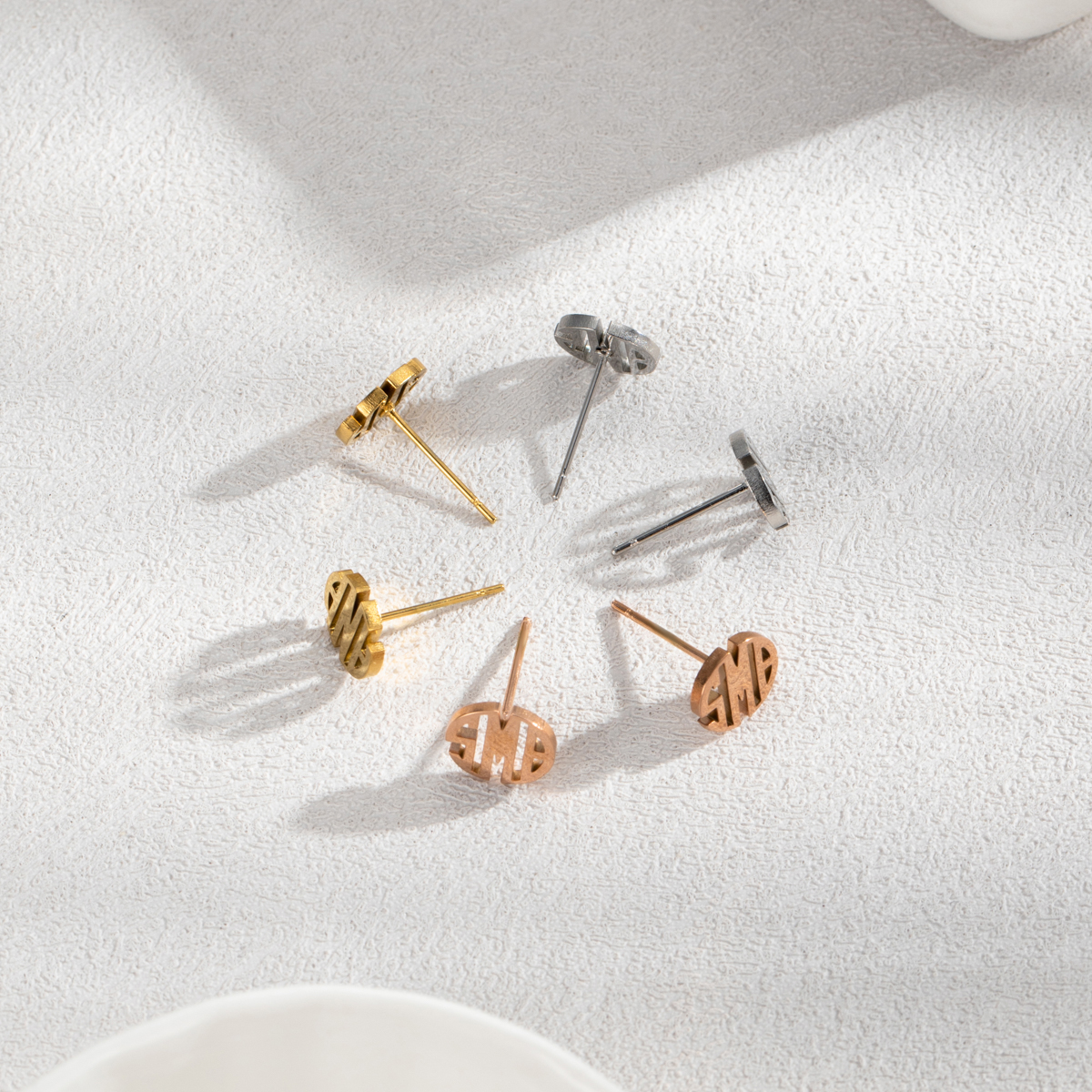 Customized round stud earrings with three letters.
