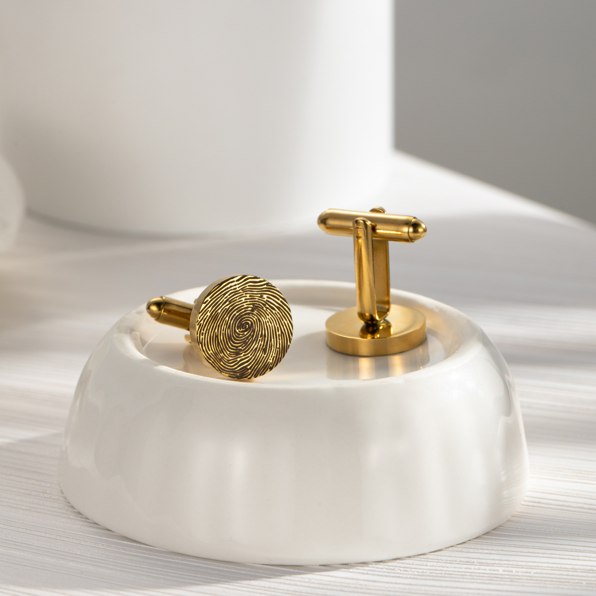 Cufflinks engraved with fingerprints of special significance.