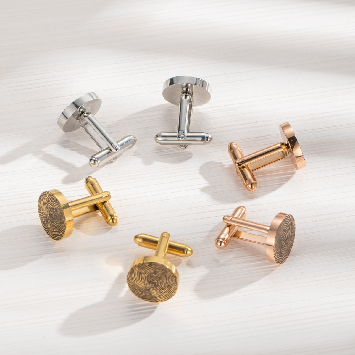 Cufflinks engraved with fingerprints of special significance.