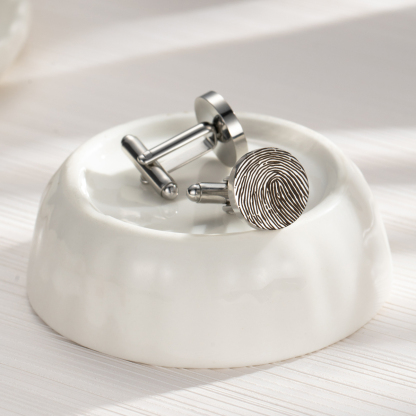 Cufflinks engraved with fingerprints of special significance.