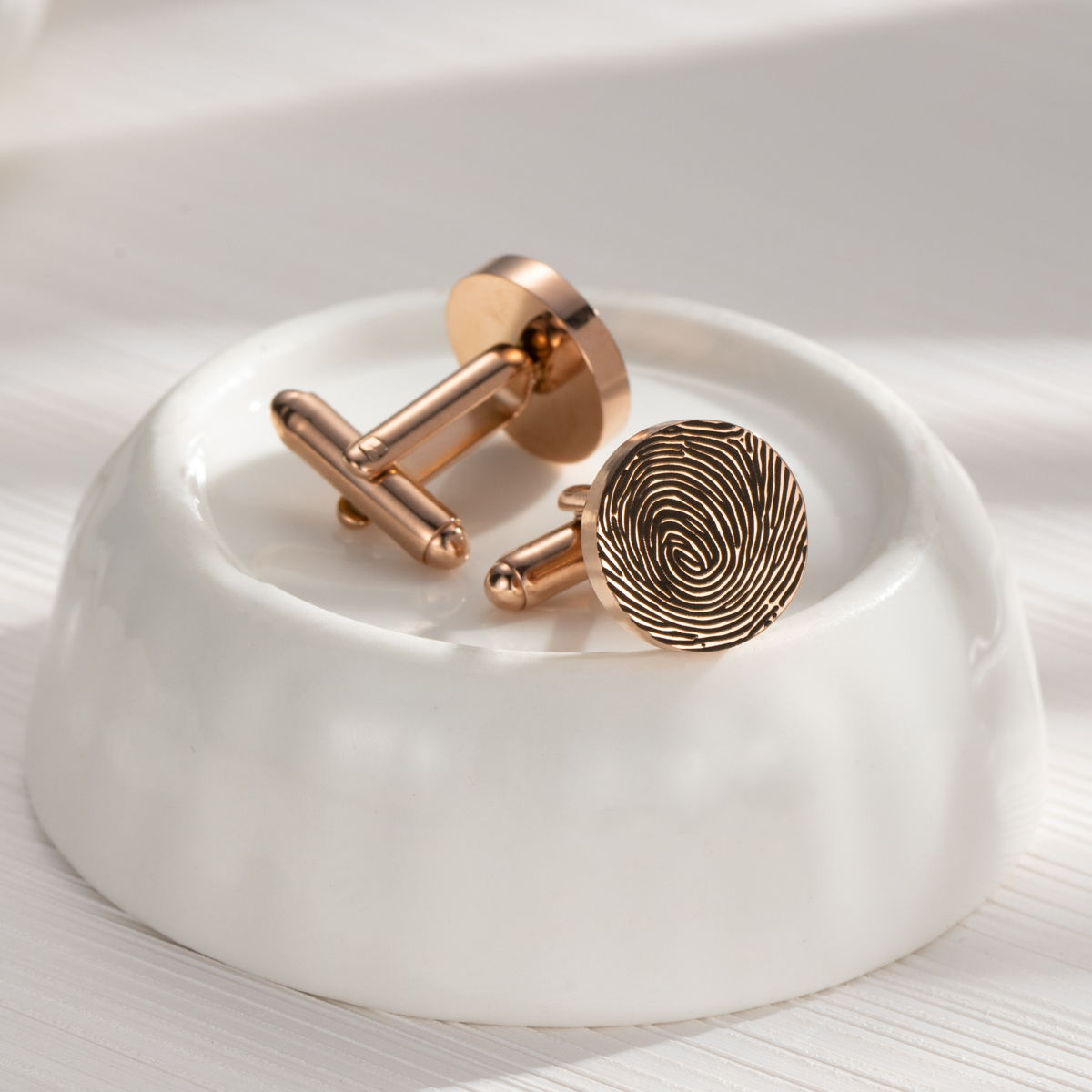 Cufflinks engraved with fingerprints of special significance.