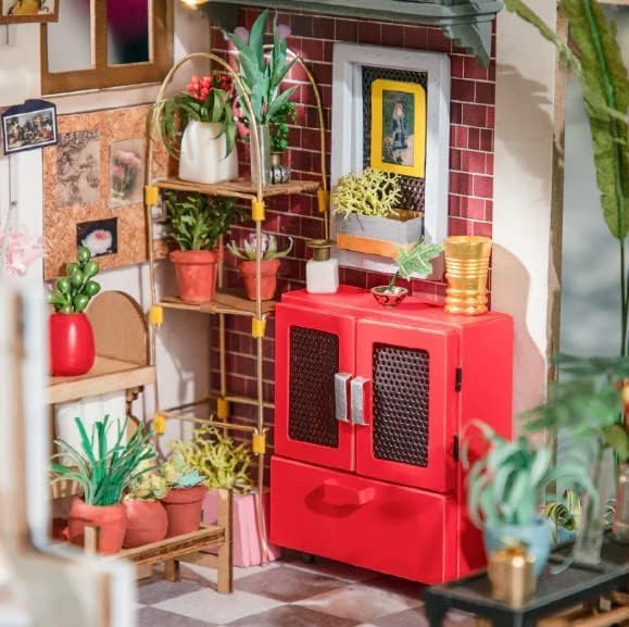 Interior close-up of the flower shop featuring a vintage red cabinet, potting bench, and cat figure.